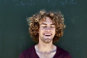Smiling blonde man with curly hair